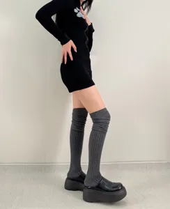 Grey ribbed over-the-knee high socks detail view, cozy winter knit leg wear for women stylish outfit.