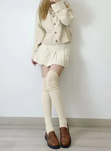 Detail shot of solid color over-the-knee high tube socks, soft vertical ribbed knit style.