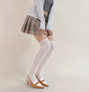 Detailed view of women's white ribbed over-knee high socks, soft cotton texture, close-up.