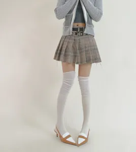 Knee-high socks detail showing soft vertical stripes and patchwork design for casual wear.