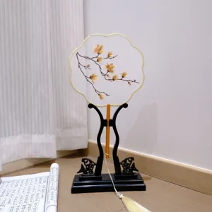 Traditional Chinese embroidered round fan with wooden stand and tassel, ancient style prop.