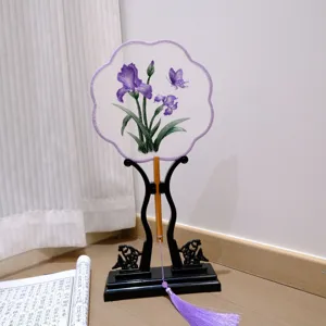 Handcrafted Chinese embroidered round fan with purple iris and tassel for Hanfu photography.
