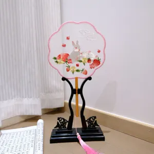 Traditional Chinese embroidered round fan with rabbit and strawberry design, wooden stand.