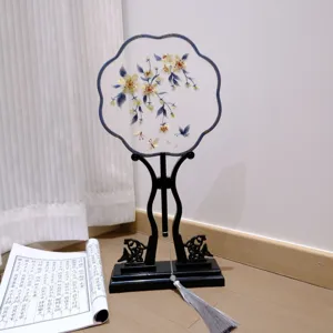 Traditional ancient style embroidered round fan with black stand and tassel for Hanfu photography.