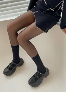 Detailed view of the stylish women fake calf pantyhose and sheer black stockings outfit.
