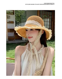 Closeup detail of women summer straw hat featuring elegant lace brim and long tie ribbons.