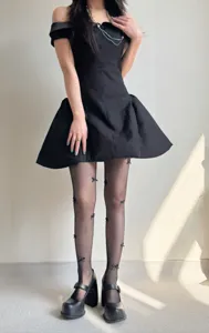 Detailed shot of black fishnet tights featuring cute 3D bows, perfect for sweet balletcore style.