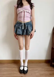 Detail shot of breathable hollow mesh white mid tube socks with delicate ruffles for summer wear.
