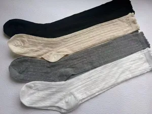 Detailed view of breathable hollow-out mesh mid-calf socks with cute lettuce edge trimming.
