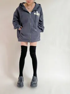Solid color over-the-knee long socks styled with casual hoodie and boots for autumn.