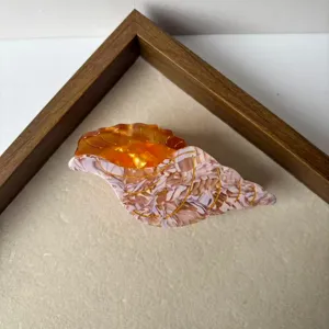 Beautiful seashell hair claw clip with pink and amber design, stylish hair accessory for women.