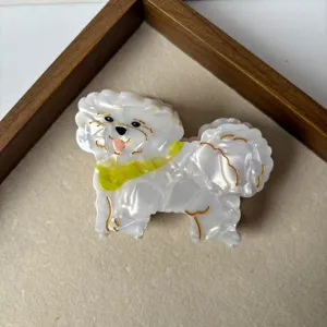Close-up detail of cute white dog hair claw clip with yellow collar, stylish hair accessory.