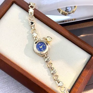Chic heart link quartz watch with blue dial and gold tone finish, exquisite jewelry style.