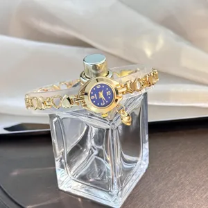 Detailed shot of the exquisite quartz watch with hollow heart pendant and blue dial.