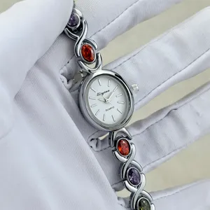 Elegant quartz wrist watch featuring an oval dial and colorful crystal link bracelet.