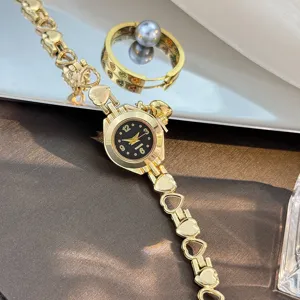 Elegant gold heart-link bracelet quartz watch with sleek black dial for stylish daily wear.