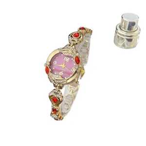Reloj de cuarzo para mujer de lujo con piedras rojas pulsera dorada esfera rosa elegante.