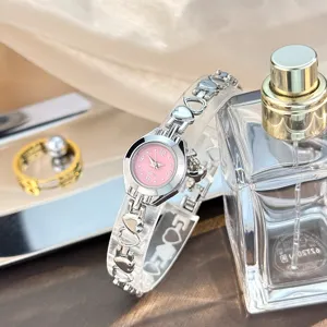 Hollow love heart bracelet quartz watch with pink dial, delicate and elegant jewelry watch.