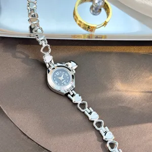 Silver heart link quartz watch with black dial, elegant and delicate jewelry wristwatch.