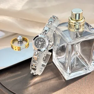 Elegant silver quartz watch with heart-shaped link bracelet, fashion jewelry wristwatch for women.