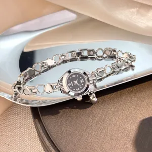 Exquisite hollow heart charm bracelet quartz watch, elegant silver metal jewelry watch.