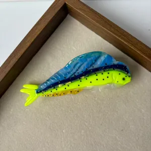 Detailed close-up shot of the ocean style fish shaped acetate hair claw clip vibrant colors.