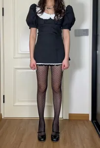 Detailed shot of black diamond pattern fishnet pantyhose for women, stylish and chic.