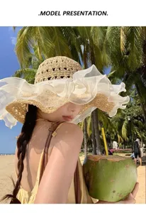 Detailed view of the women summer large brim straw sun hat with white mesh lace ruffle.