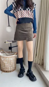 Detailed view of the stylish outfit showcase, featuring textured pantyhose and cozy room setting.