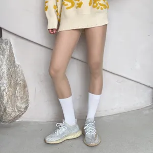 Fake calf socks pantyhose featuring spliced design paired with stylish sneakers for women.
