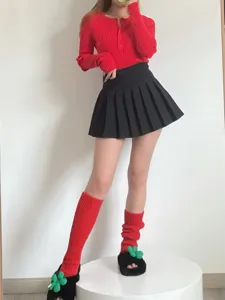 Detailed view of cozy knit leg warmers paired with stylish autumn and winter outfit.