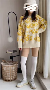 Detailed view of the women casual knit sweater and over knee socks outfit showcasing details.