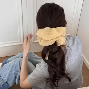Yellow plaid chiffon scrunchie detail view, elegant vintage hair tie for women ponytail.