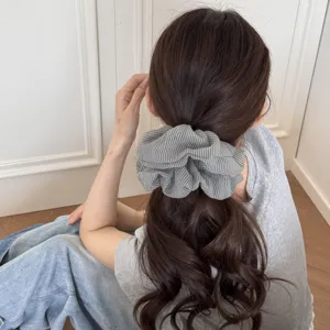 Chic plaid hair scrunchie for women, retro pleated elastic ponytail holder accessory style.