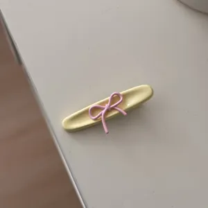 Grazioso fermaglio per capelli con fiocco, accessorio giallo e rosa stile dolce.