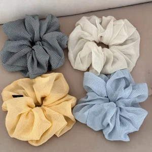 Detailed view of four colorful checkered chiffon hair scrunchies, vintage ruffled design for daily wear.