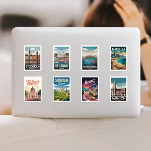 Detailed view of vintage European city travel graffiti stickers applied on a laptop.