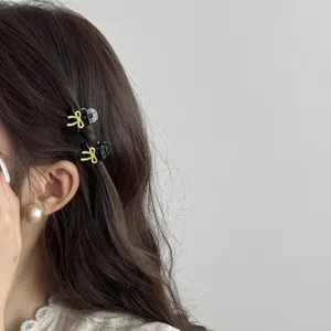 Mini bow hair claw for women, cute black small hair clip with yellow bow for side bangs.