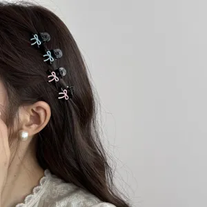 Korean style mini bow hair claw clip detail close-up for sweet side fringe and bangs styling.
