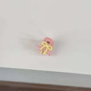 Mini pink hair claw clip with a cute yellow bow detail, perfect for side bangs and cute hairstyles.
