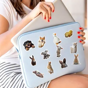 Detailed scene of cute animal stickers displayed on a laptop sleeve for waterproof decor.