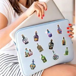 Detailed close-up view of magical witch potion bottle stickers applied on a laptop sleeve.