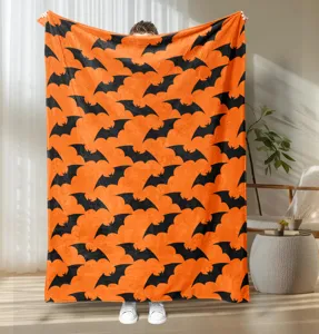 Detail shot of Halloween bat printed flannel blanket in indoor scene showcasing soft fabric and pattern.