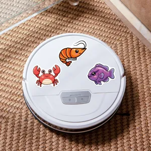 Waterproof cute marine animal stickers displayed on a smart robot vacuum cleanly.