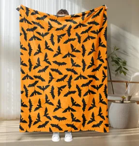 Detailed view of Halloween bat print flannel blanket cozy holiday home decor soft texture