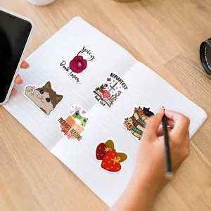 Detailed close-up of creative book lover theme decorative waterproof stickers on a notebook.
