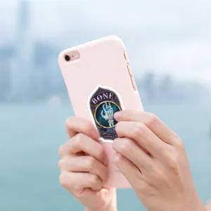 Detailed view of a creative witch potion sticker featuring a skull hand design on a phone.