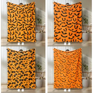 Cozy Halloween flannel blanket with orange and black bat print, perfect for home decor and warm use.
