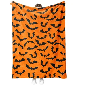 Halloween orange fleece blanket with black bats print, cozy soft throw for holiday home decor.