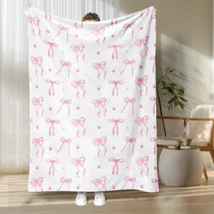 Cozy pink bow print flannel blanket, soft fleece throw for bedroom, living room, and home decor.